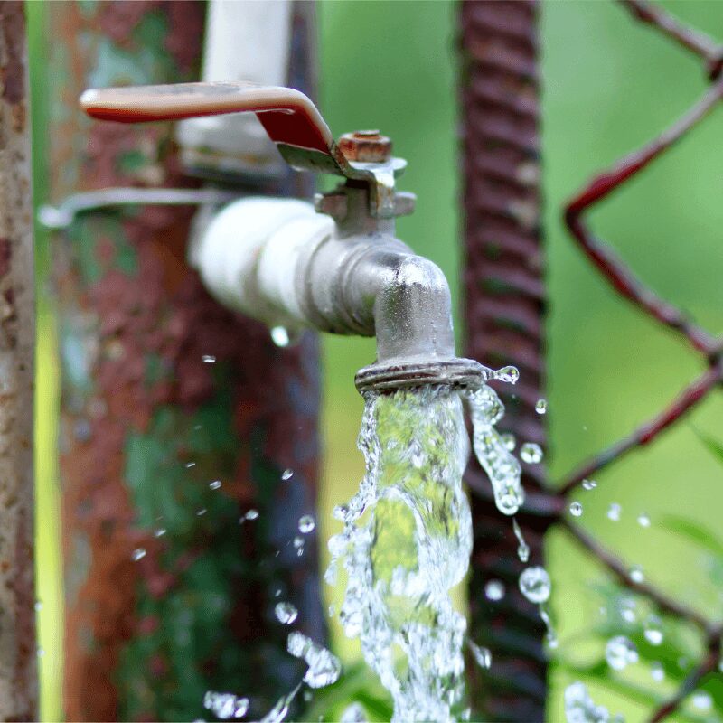 close-up-of-grunge-brass-faucet-on-green-bokeh close up of broken outdoor faucet